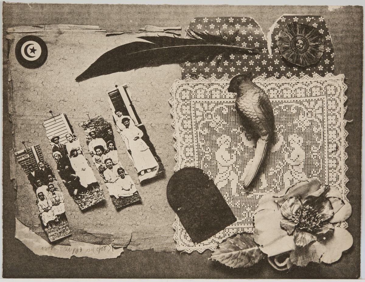 A photograph of a collection of objects, like a feather, textiles, flowers, and a photograph