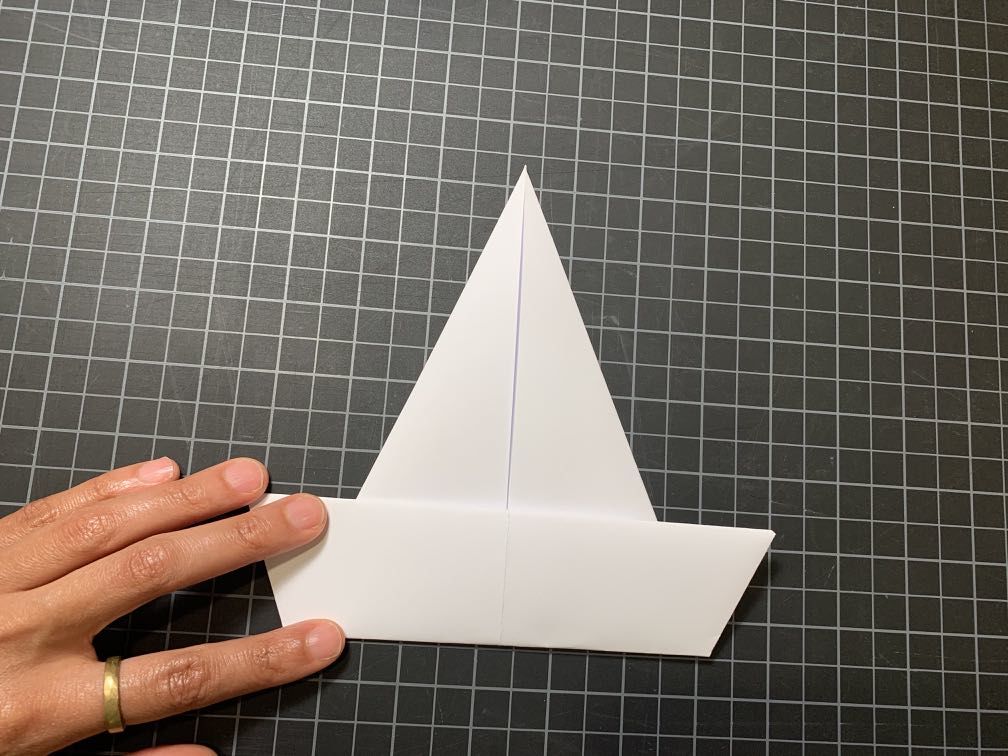 Triangle shaped piece of paper with bottom fourth folded up to create a rectangle shape