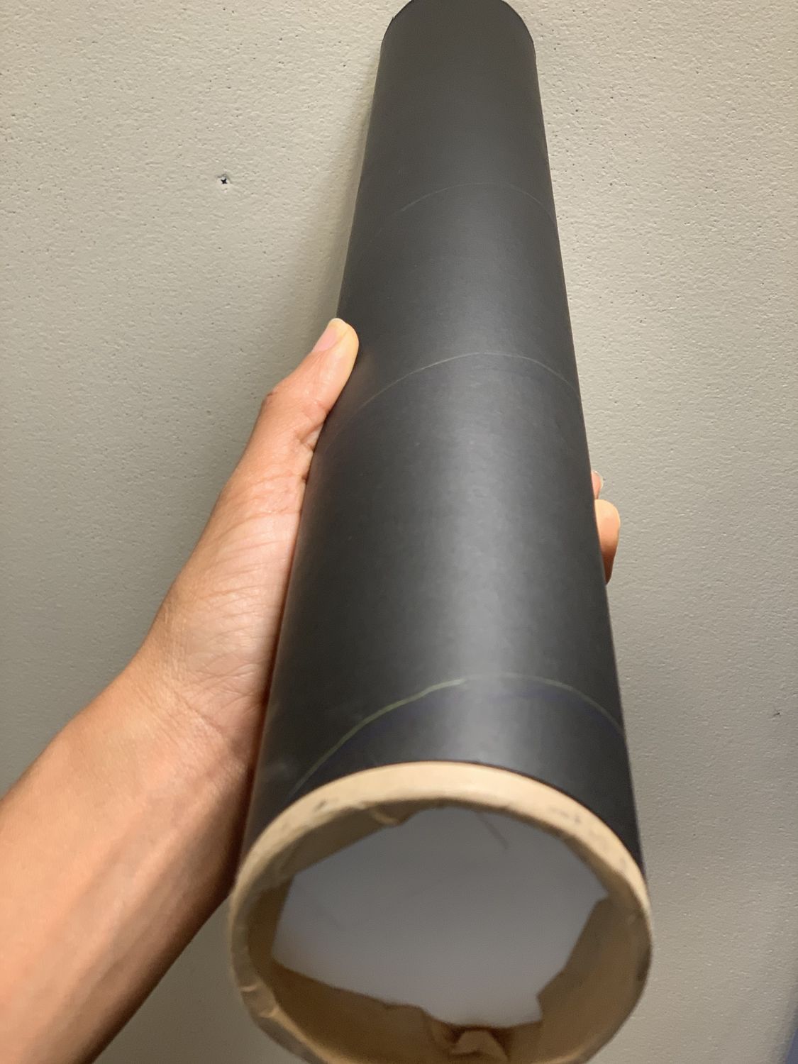 Cardboard tube covered in black butcher paper