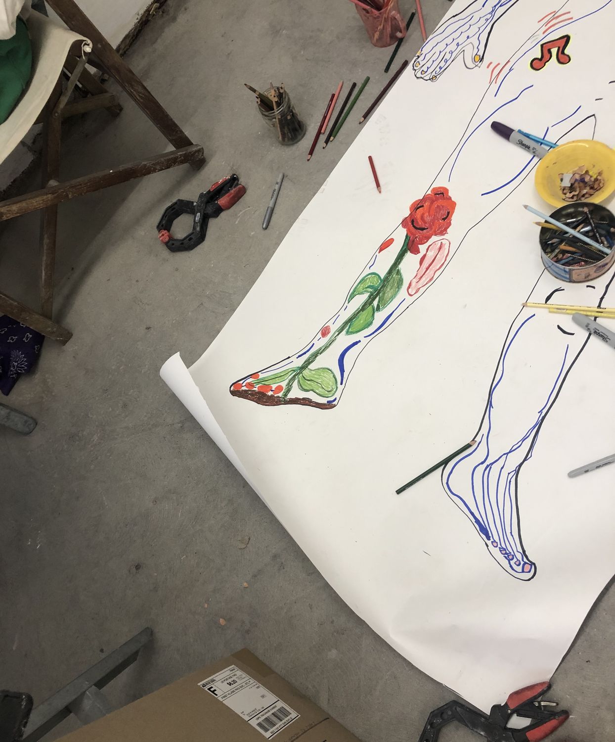 Drawing of foot with blue lines from toes to ankle on right foot, left foot drawn with red rose with green stem and leaves