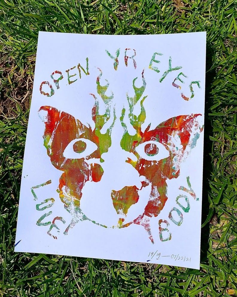 A screen print that says "open yr eyes love body"