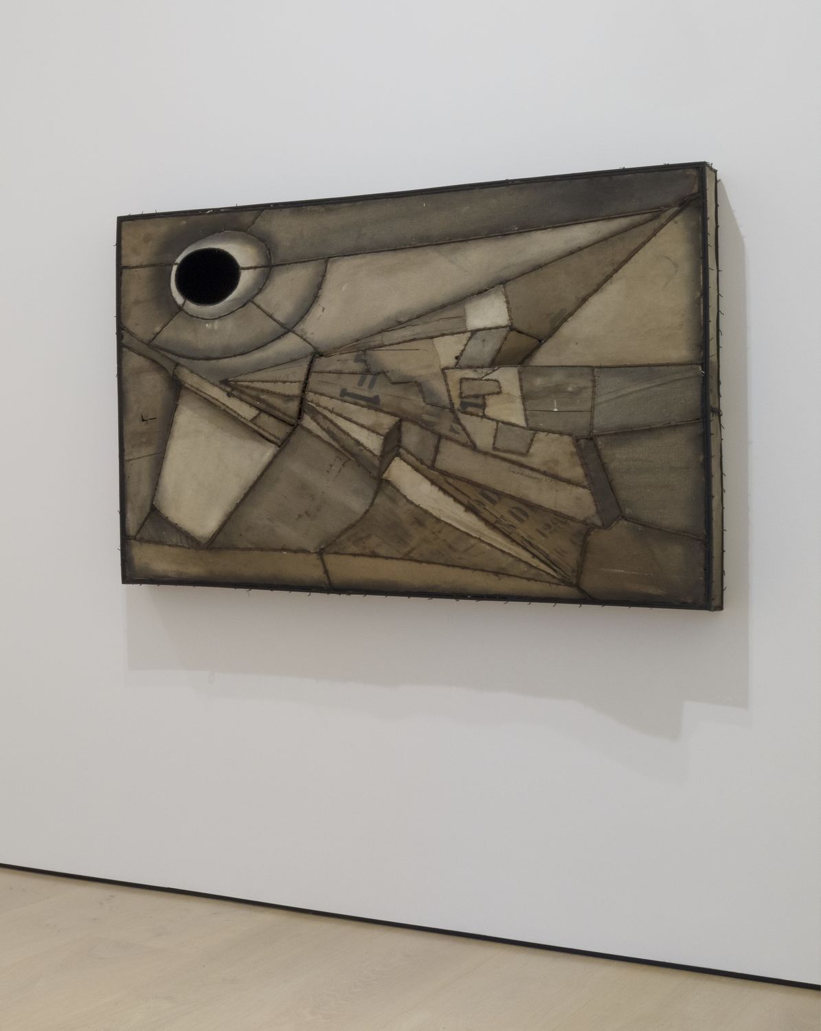 an abstract painting hang on the white wall