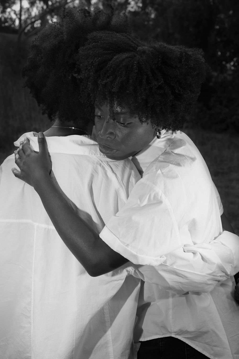Two Black woman embrace each other