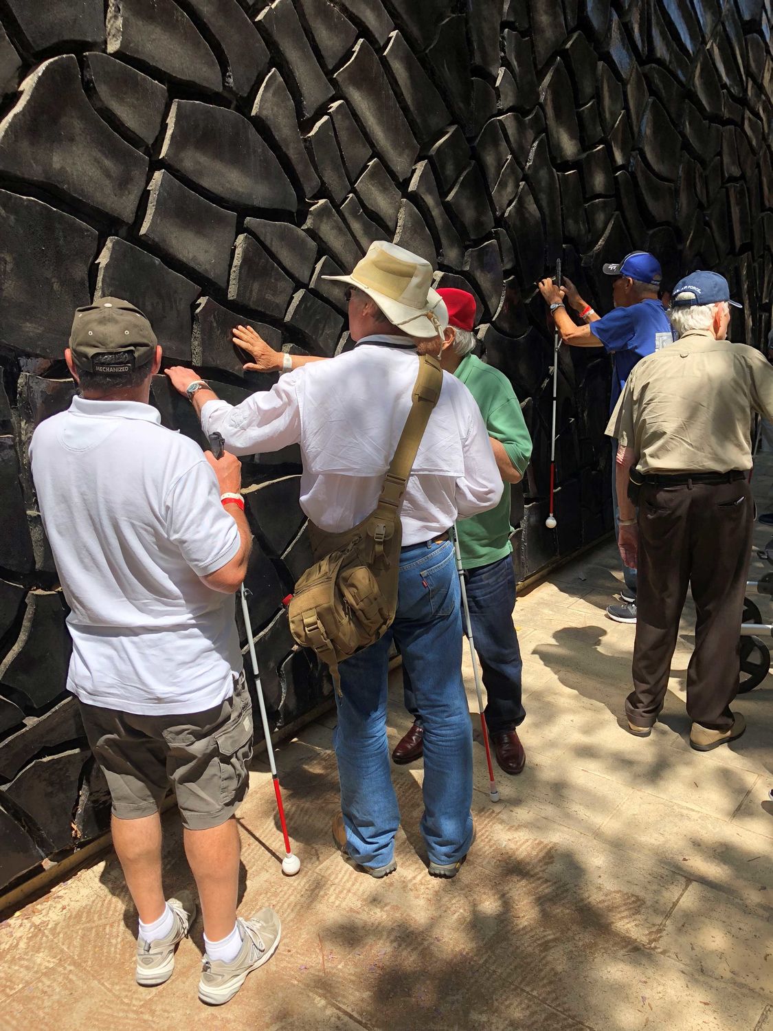 Veterans exploring Alberto Burri's Large Black Cretto