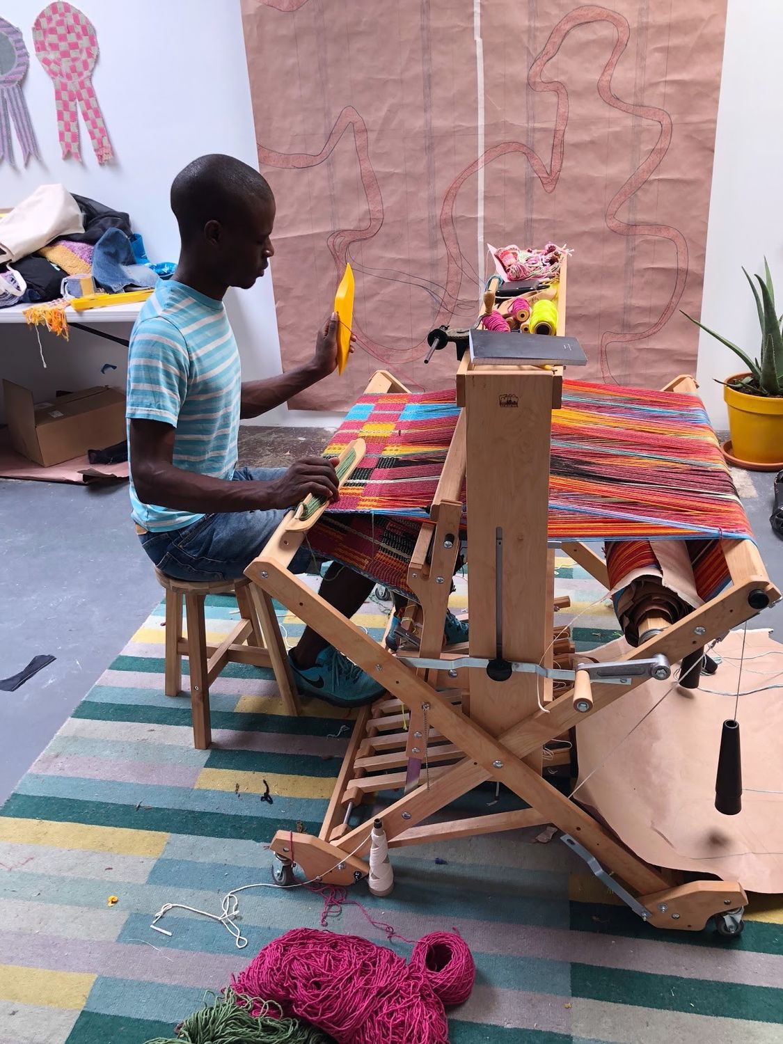 Diedrick working on his loom in his studio