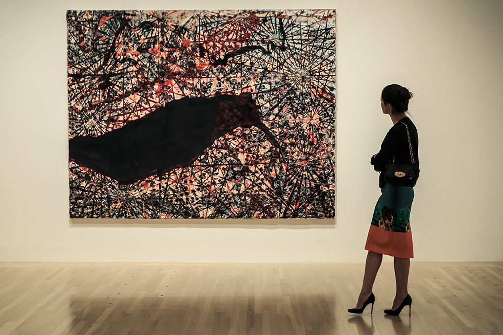 woman looking at painting