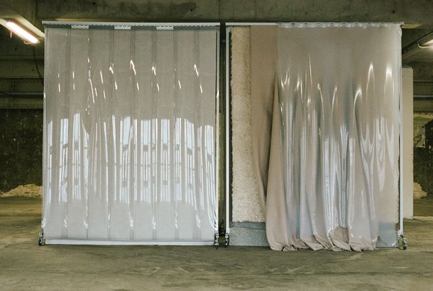 Two plastic curtains hang from standing racks