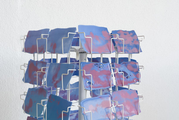 Postcard rack stocked with postcard-sized images of the sky