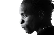 Black-and-white photo of a man in profile. Photo is close-cropped - the top of his is not visible. He looks ahead with no expression, as if in deep thought.