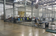 Detainees in a fenced in area inside a detention facility in McAllen, Texas. 