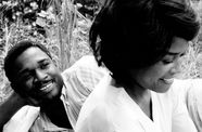 Still from the film Nothing But a Man (1964) showing a man lying in the grass looking lovingly at a woman