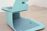 A pale blue sculpture covered in dark blue tiles