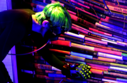 A man in a mask and gloves examines a stack of books
