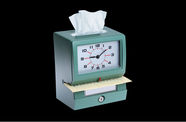 A punch-in clock with a tissue sticking out of the top
