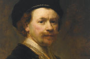 A portrait of a man with facial hair in a black hat