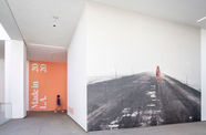 A hallway at the Hammer Museum, with a black-and-white photograph covering a whole wall, and a pink wall with Made in L.A. 2020 on it in the background