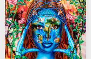 A colorful painting of a woman whose face is the earth, with the words Earth Angel above her head
