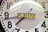 Still from the 1982 documentary film "Fear of Poetry," showing close-up for a circular clock with the work "poetry" in the center.