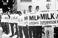 Still from the film "The Times of Harvey Milk" (1984), showing a group of men holding political campaign signs that say "Harvey Milk Supervisor"