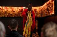 Masked performer hold blanket