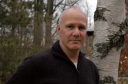 Headshot of man in a forest.