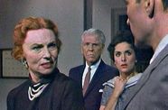 Two women and two men look at each with concerned and annoyed faces.