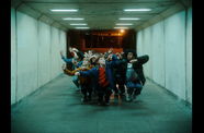 Still from the music video for "Butterflies" by Skrillex ft Starrah & Four Tet, showing a group of dancers crouched in a tunnel