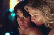 Two women hold each other. 