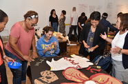 A group of teachers talk casually while working on a crafting activity