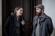 A woman and a man speak to each other