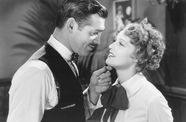 A woman and a man look tenderly at each other.