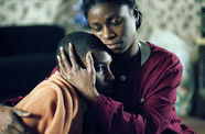 A mother holds her young son. 