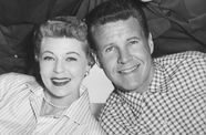 A woman and 3 men smiling for a portrait. 