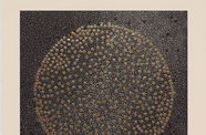 A square, geometric print of a circlemade of gold dots sits on a background of black-and-white spots