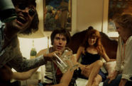 Group of friends sit in bedroom