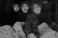 3 Triplets make different expressions next to each other in black and white photo.