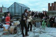 The Beatles perform on a rooftop in a still from the film "The Beatles: Get Back" (2021)