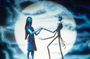 Skeletons hold hands as silohouette's in front of a setting moon