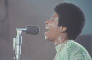 Aretha Franklin sings into microphone