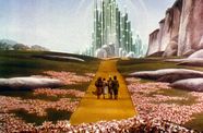 Characters walk down yellow brick road