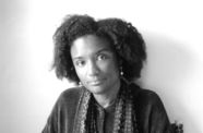 Harryette Mullen, holding an open book on her lap