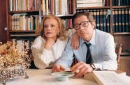 A middle aged man and woman look towards an inferred audience