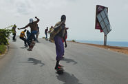 Men skate down hill