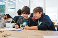Two kids work on an art activity