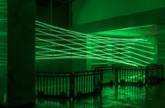 Green lasers fill a room