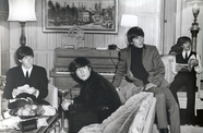 The beatles sit around the studio, shot in black and white