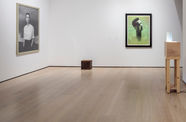 Installation view of four works, including a cube on the floor