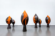 Six earthenware sculptures, in black and orange, in the shape of a spade
