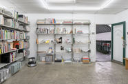Photo of shelves filled with books, objects, and ephemera