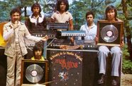 Archival photo of six men, two holding framed records